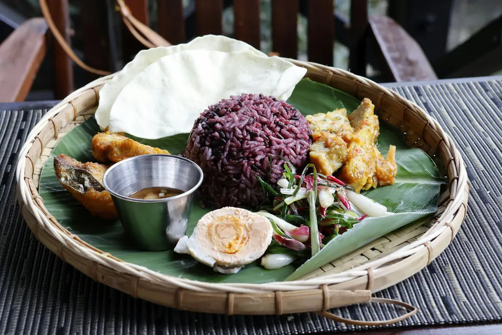 A platter of rice, egg, and other food items